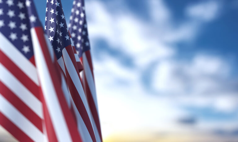 American flags with the sky in the background