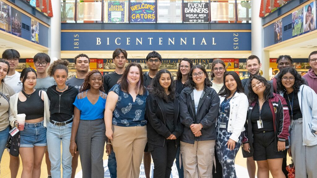 a group of people posing for a photo in front of a sign that reads bicentennial