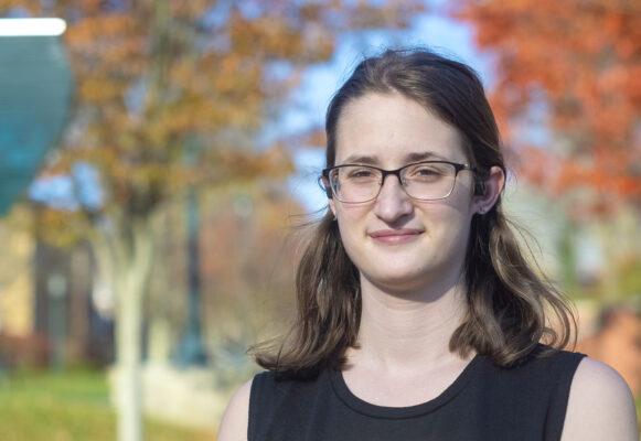 a person with long hair wearing glasses