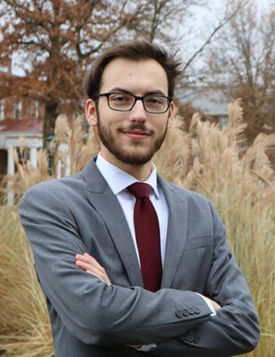 a person in a suit with his arms crossed