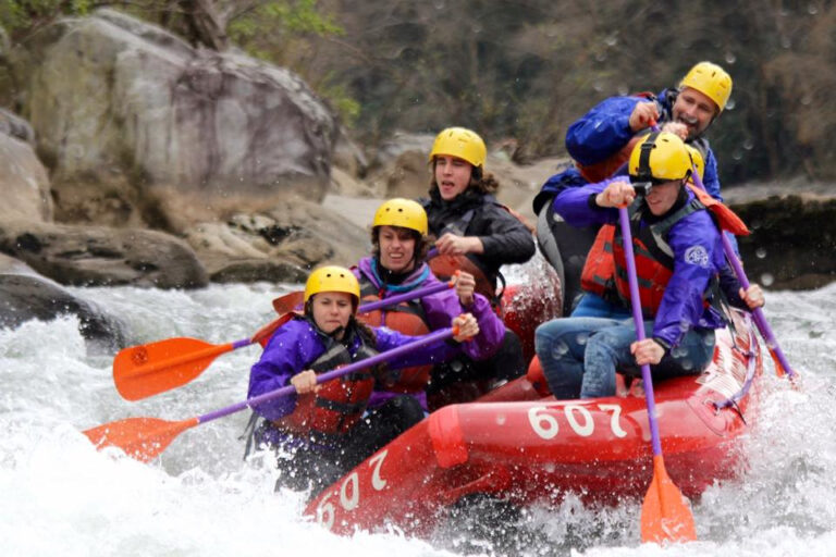 a group of students in a raft on a river