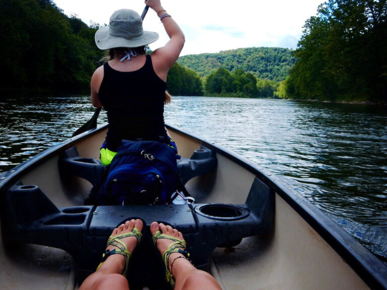 two students in a canoe on a lake