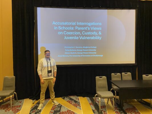 Professor standing in front of presentation screen