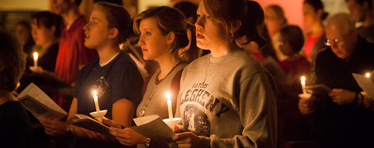 a group of students holding candles