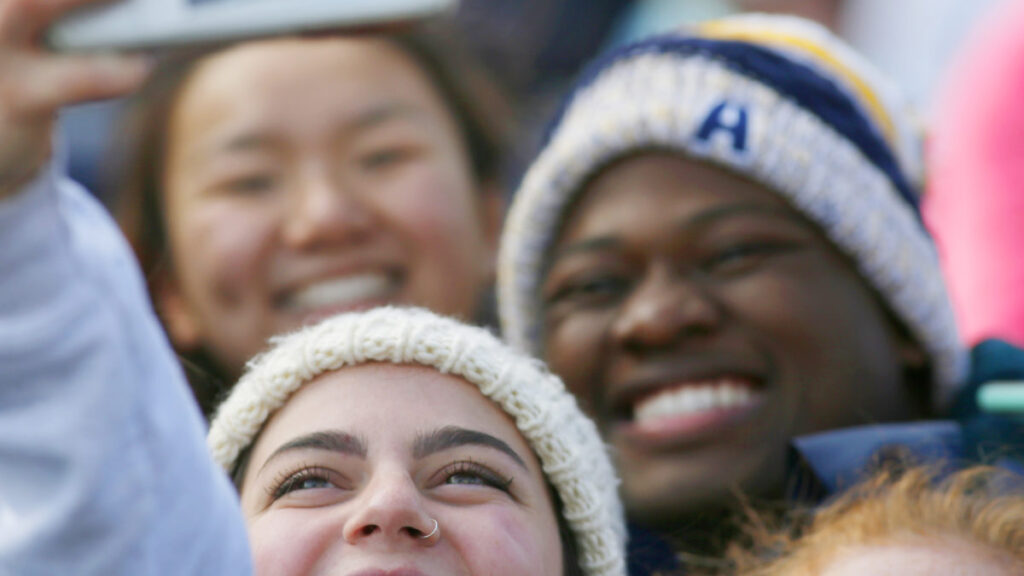 a group of students smiling and looking upward