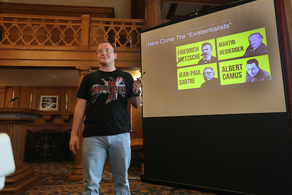 a person standing in front of a large screen