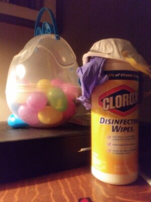 a container of disinfectant wipes and a bucket of balloons